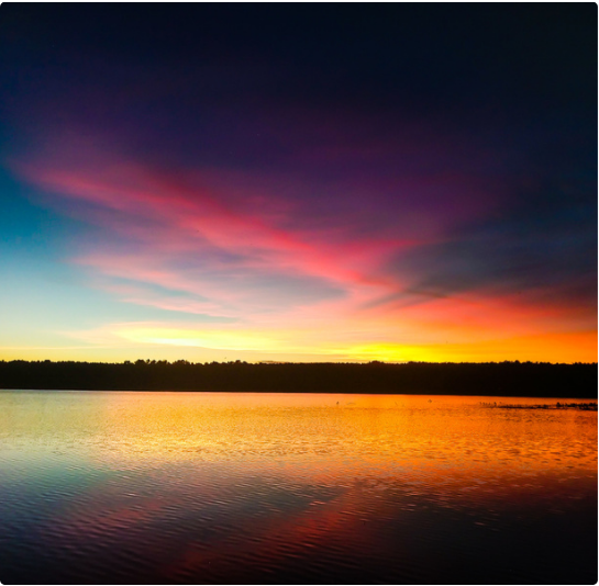 Sunset over water at a wellness retreat